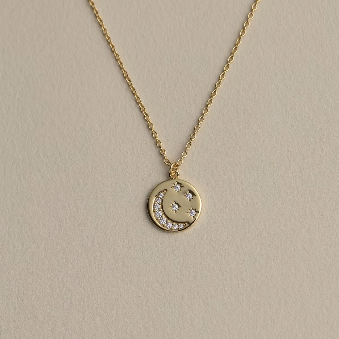 Declaras vintage 18K gold plated sterling silver celestial medallion necklace featuring an embossed crescent moon and starbursts encrusted with pavé cubic zirconia